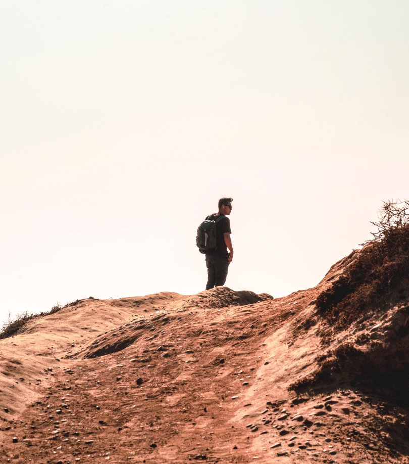 Lone man at the top of a dune