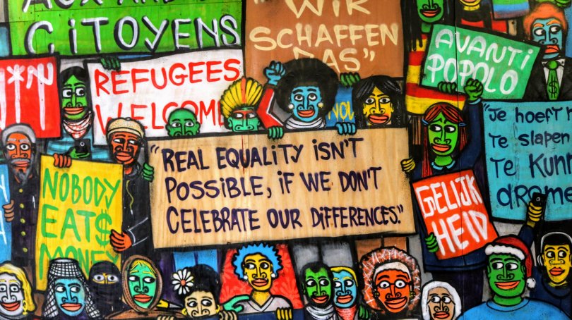 tags on a wall with messages on the theme of equality