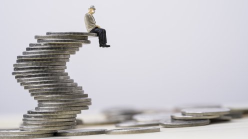 Man sitting on a stack of coins